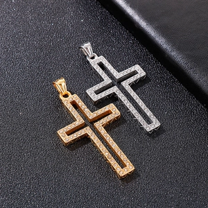 Detailed view of gold and silver cross pendants with shimmering inlaid rhinestones