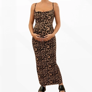 Close-up detail of leopard print patterns and backless sling design on a maternity maxi dress