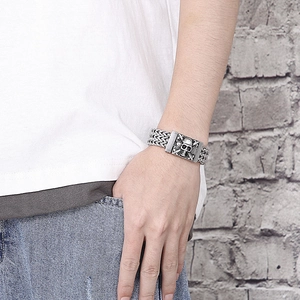 Men's retro stainless steel skull bracelet worn on wrist with punk curb chain detail