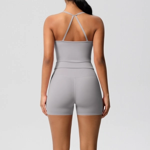 Detail of grey yoga set showing criss-cross back straps and high-waist sports shorts