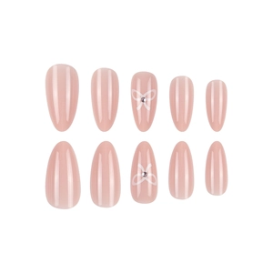 Elegant almond-shaped nude pink press-on nails with white bow and tiny rhinestone accents