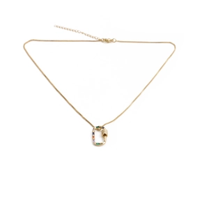 Macro view of gold carabiner necklace with multicolor gemstones and lobster clasp closure