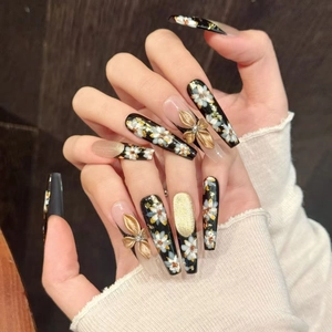Vintage floral press-on nails in long coffin shape with 3D gold flowers and black accents