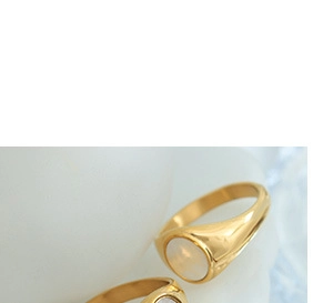 Macro detail of 18K gold-plated titanium rings with mother of pearl sun moon inlay