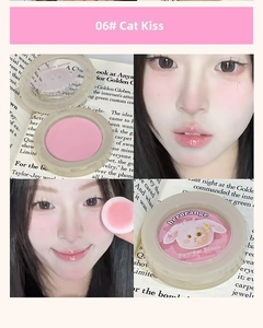 Macro detail of soft sakura pink powder blush featuring cute cat ear illustration cover