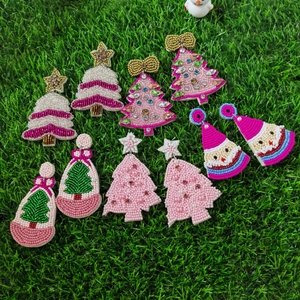 Flat lay of handmade Christmas beaded earrings with Santa and pink tree motifs