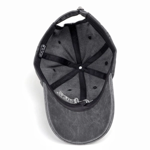 Detail of washed grey cotton baseball cap with adjustable metal buckle and embroidery