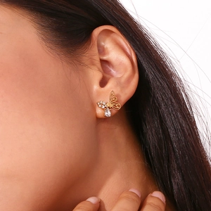 Close-up of 18K gold plated asymmetric butterfly stud earrings with sparkling zircons