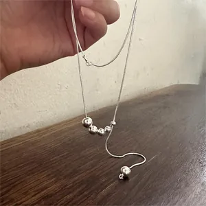 Detailed view of 925 sterling silver beaded necklace with sleek snake chain craftsmanship