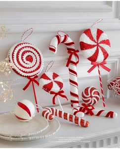 Macro detail of red and white glitter candy cane and lollipop Christmas ornaments