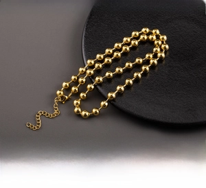 Detailed macro view of an 18K gold plated stainless steel bead chain necklace for women