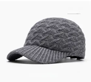 Detail shot of the dark grey knitted baseball cap showing thick cable knit texture