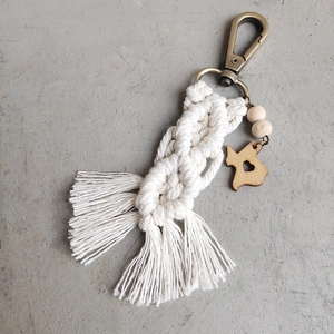 Detail of macrame keychain featuring Texas wood cutout, white cotton rope and wood beads