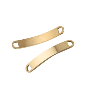 Macro view of two curved golden stainless steel connectors with dual holes for DIY jewelry