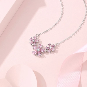 Elegant S925 silver necklace featuring pink gemstone floral pendants with romantic ribbons