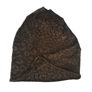 Close-up of leopard print plush texture on dark brown slouchy beanie hat for winter