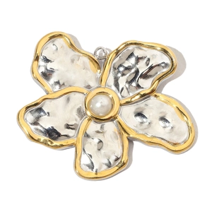 Macro view of flower pendant featuring silver hammered metal and centered white pearl