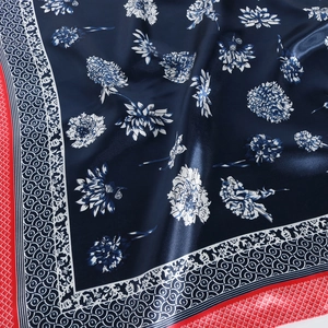 Dark blue satin square scarf with white floral patterns and red geometric borders