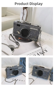 Detail of glitter camera-shaped crossbody bag with rhinestone accents and silver chain