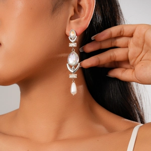 Silver drop earrings with rhinestones and pearls on model, elegant geometric jewelry