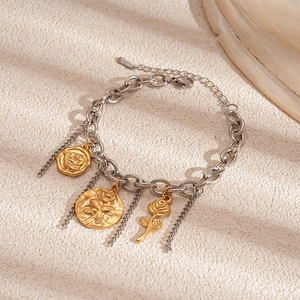 Detailed macro of vintage silver chain bracelet with golden rose relief coin pendants
