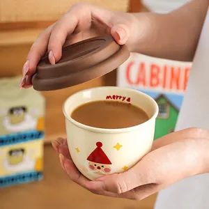 Christmas Santa ceramic coffee mug with brown silicone lid and festive Merry pattern