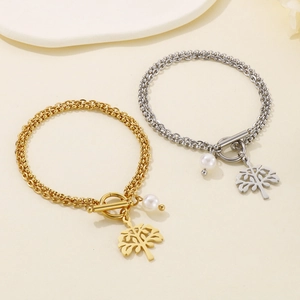 Detail of gold and silver double-layer tree pendants and OT toggle clasps on bracelets