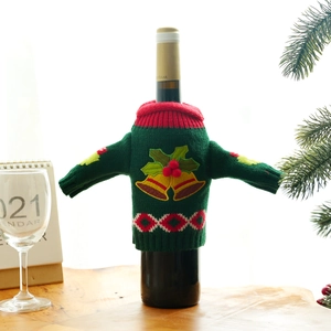 Knitted Christmas wine bottle cover in green and red with festive berry embroidery