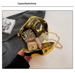 Internal view of gold irregular pebble clutch bag showing capacity for phone and makeup