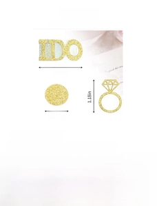 Close-up of gold glitter I DO confetti and diamond ring shapes for engagement decor