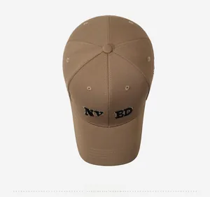 Top view of khaki cotton baseball cap featuring embroidered NY&ED letters and structured crown