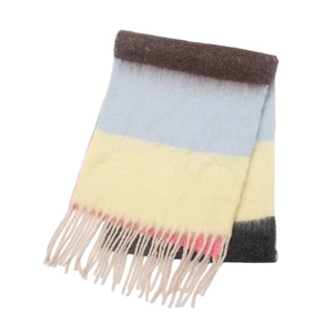 Detail of colorful striped knit scarf featuring fringe tassels and thick bouclé yarn texture