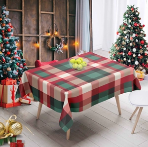 Festive red and green plaid Christmas tablecloth on a wooden dining table