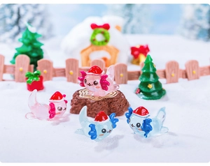 Miniature Christmas axolotl figurines with Santa hats and festive holiday scenery