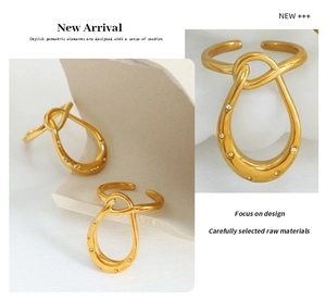 Detail of gold geometric ring with twist design and micro-set cubic zirconia stones