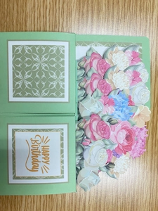 Macro detail of 3D popup flower bouquet inside a green Happy Birthday greeting card