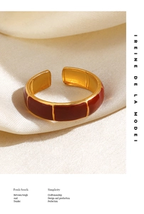 Detail of bamboo joint style open ring with reddish brown enamel and golden plating