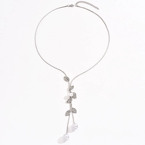 Elegant silver leaf sweater necklace with rhinestones and white pearls on white background