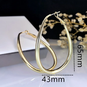 Detailed view of large gold teardrop hoop earrings with 65mm height and 43mm width