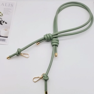 Close-up of green 6mm leather cord handle with golden spring hooks and knotted design