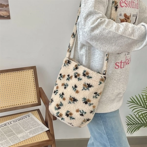 Detail of plush floral tote bag showing soft faux fur texture and green flower pattern