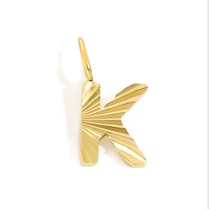Detailed view of a gold-plated letter K pendant with radial texture and polished finish