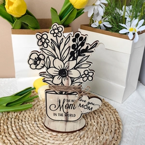 Detail of wooden flower ornament engraved with THE BEST Mom IN THE WORLD message