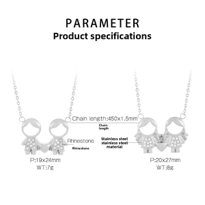 Detailed view of stainless steel boy and girl pendants with rhinestone embellishments