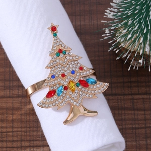 Sparkling Christmas tree napkin ring with colorful crystals on a white fabric napkin