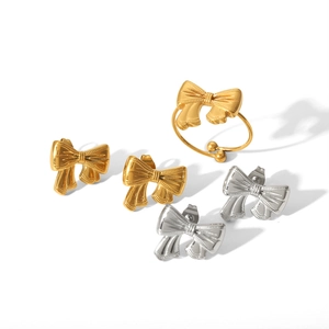 Polished 18k gold and silver bow stud earrings and adjustable open ring jewelry set