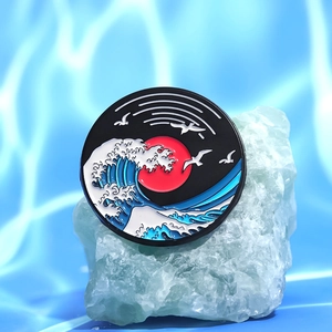 Creative enamel badge featuring Great Wave and red sunset on a decorative green stone