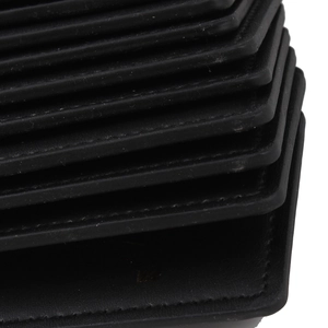 Macro side view of black multi-layered leather luggage tag showing fine stitching details