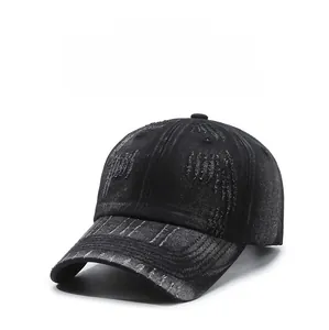Detail shot of distressed vintage black denim baseball cap with stylish ripped holes