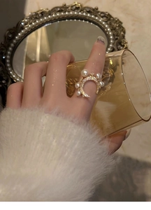 Close-up of star and moon ring with pearls and zircons on a woman's hand
